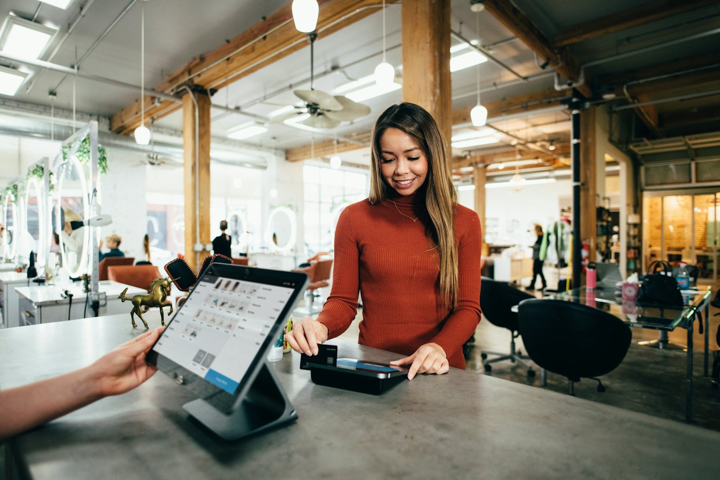 A retail checkout counter using a point-of-sale tablet