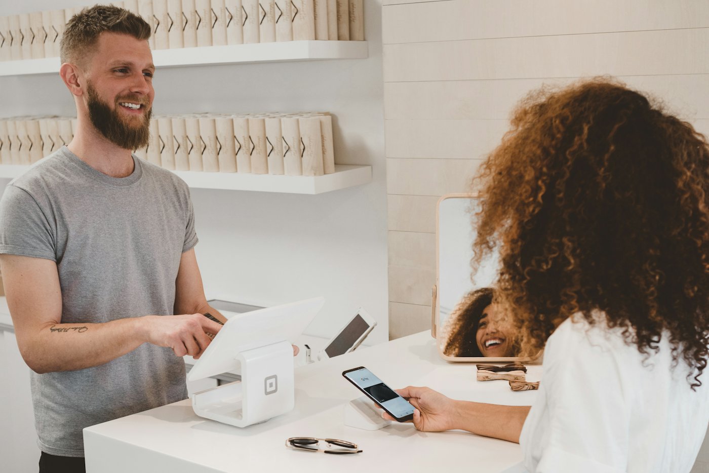 A small shop owner completing a transaction with a customer